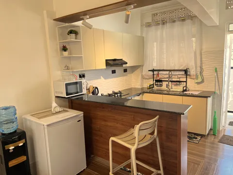 Wangs BnB kitchen with cream cabinetry and a breakfast bar.