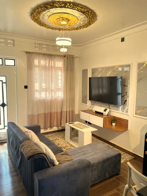 Wangs BnB living area with a grey sofa and white coffee table.