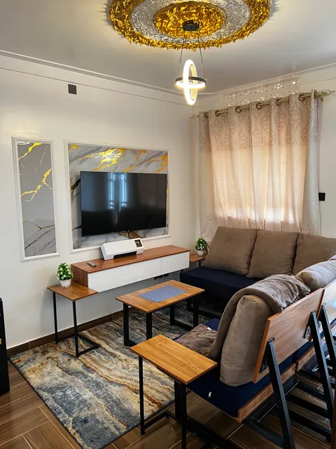 Nova sofa and coffee tables beneath the decorative living-room ceiling light.